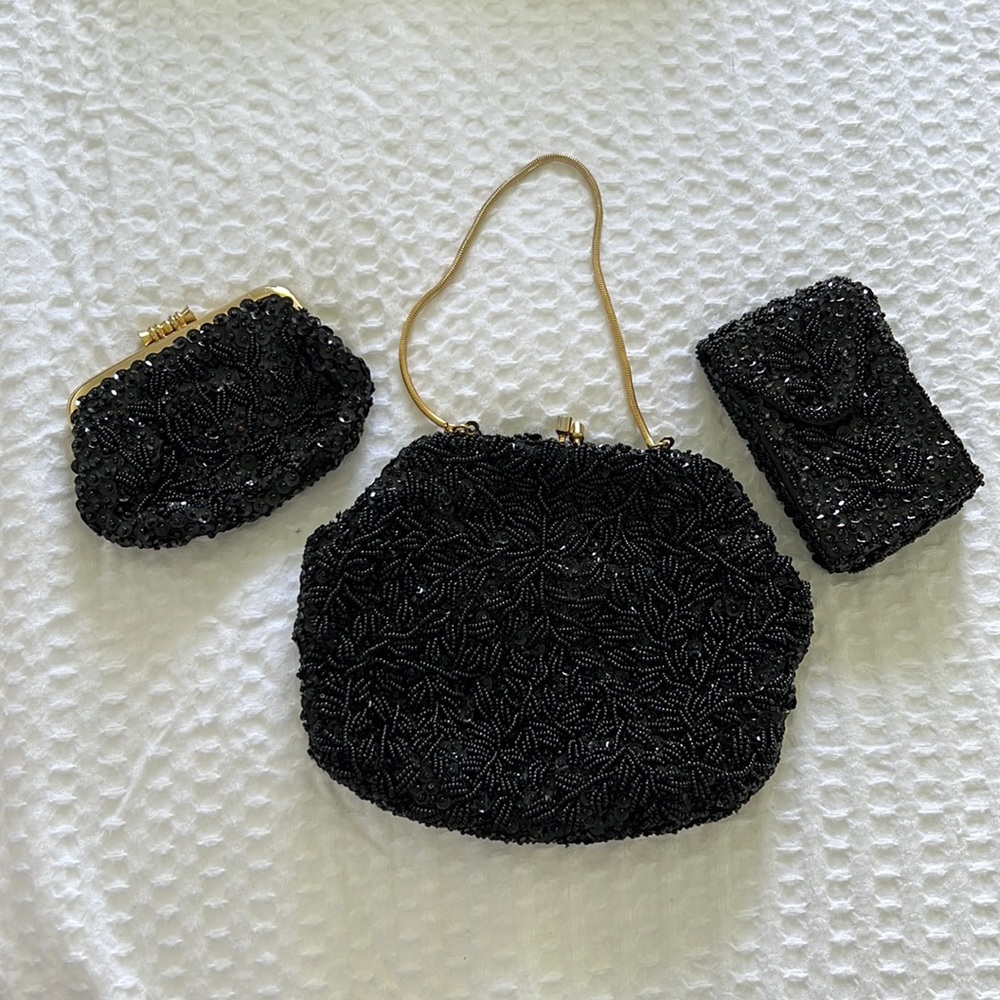 Black clasp. Included is a smaller bag and a phone holder.